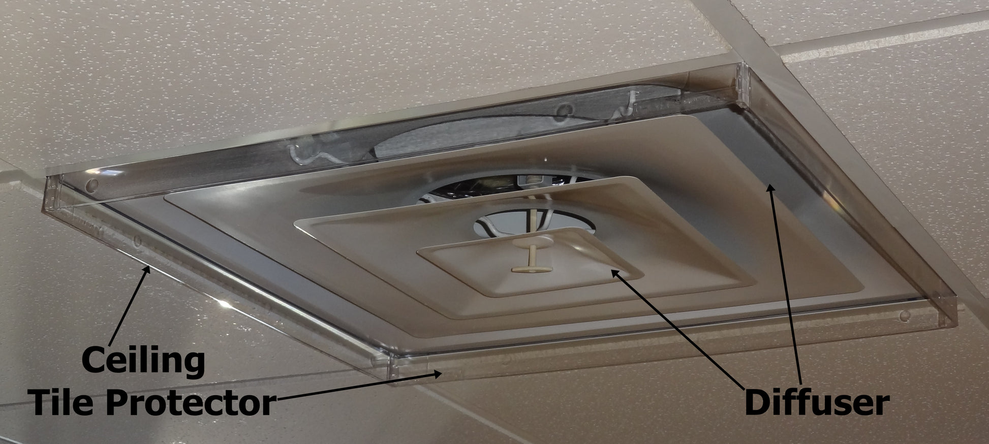 Close up of Airtech Inserts Plastic Ceiling Tile Protector in place on ceiling vent in a commercial setting with black labels identifying the Protector and Diffuser